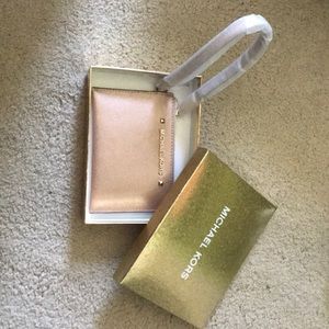 A Micheal Kors Rose Gold Hand Clutch